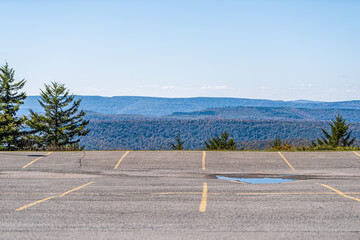 Empty parking lot in small skiing resort town village of Snowshoe, West Virginia in autumn with nature view on Allegheny mountains
