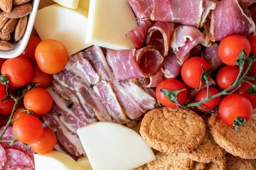 meat and vegetables - Top view of plate full of food. Cherry tomatoes with bacon, ham, cheese.