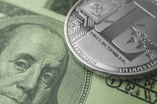 Litecoin and dollar bills close-up view background, crypto exchange and trading, new virtual money concept photo