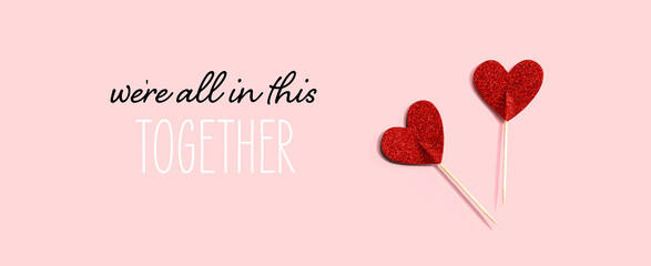 We are All in This Together message with red glitter heart picks