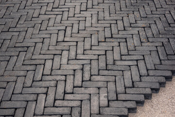 Paving stone driveway installation, 90 degree pattern laid by hand.