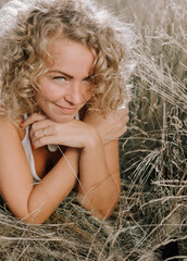 woman curly hairstyle outside field freedom sunset