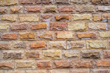 A fragment of a textured wall made of turned bricks