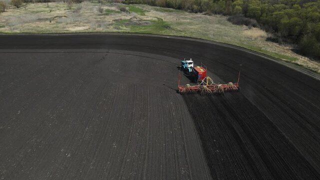 tractor drives across the field and plows the land. aerial shooting