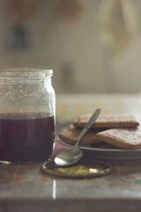 Jar of charry-strawberry jam with cookies. Morning still-life. Pleasant pastel colors, soft light. Good illlustration for postcard, journal, book.