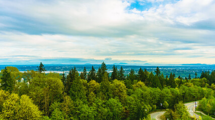 View south from UniverCity Highlands on Burnaby Mountain across Fraser Valley and river to Gulf Island on horizon