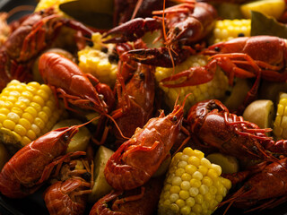 King prawns with boiled corn. Brightness of colors. Contrast. Very close-up. Texture. Wallpaper. Delicious and healthy dish. Healthy eating. Vitamin food