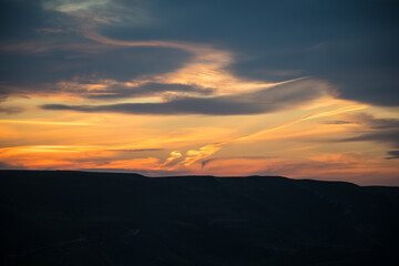 Colorful sunset over the mountain hills. Beautiful clouds flying over the lake near mountains. Evening time shot over the clouds. Baku, Azerbaijan.