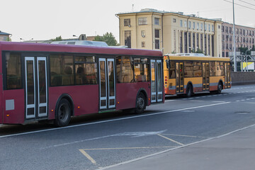 Fototapeta na wymiar City buses move along the street