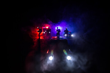 Fototapeta na wymiar Police cars at night. Police car chasing a car at night with fog background. 911 Emergency response police car speeding to scene of crime.