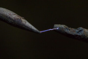 Electric cable close-up with glowing electricity lightning. Macro shot