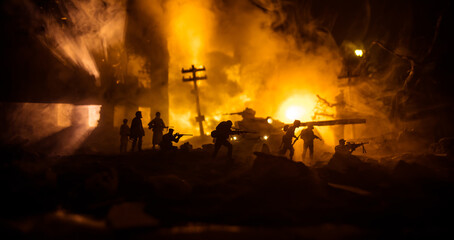 War Concept. Military silhouettes fighting scene on war fog sky background, World War Soldiers Silhouette Below Cloudy Skyline At night. Battle in ruined city.