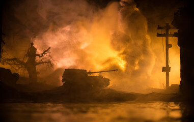 Obraz premium War Concept. Military silhouettes fighting scene on war fog sky background, World War Soldiers Silhouette Below Cloudy Skyline At night. Battle in ruined city. Selective focus