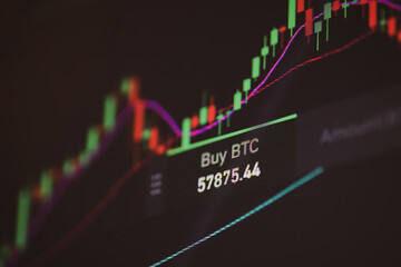 Shallow depth of field footage with details of Bitcoin cryptocurrency price fluctuations on a crypto exchange app, on a digital screen.
