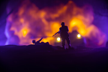 Naklejka na ściany i meble War Concept. Military silhouettes fighting scene on war fog sky background, World War Soldiers Silhouette Below Cloudy Skyline At night. Battle in ruined city. Selective focus