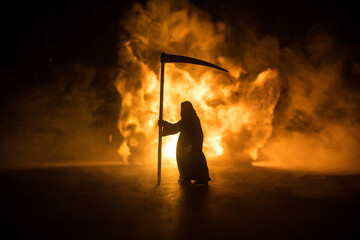 Scary view of grim reaper at cemetery with spooky cloudy sky and fog, Horror Halloween concept....