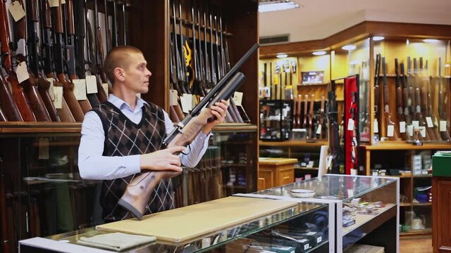 Air rifle in the hands of the owner of the gun shop. High quality FullHD footage