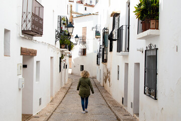 Woman strolling in a beautiful white street