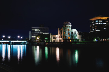 The Atomic Bomb Dome, memorial for the second world war, along the river in the night, Hiroshima, Japan