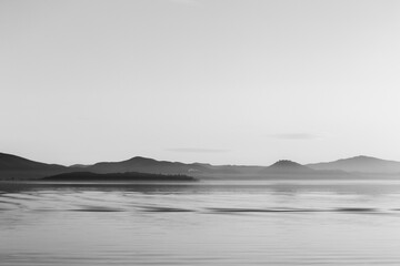View of Trasimeno lake in Umbria, Italy, with empty sky and beautiful water reflections with ripples. Otherworldly stillness.