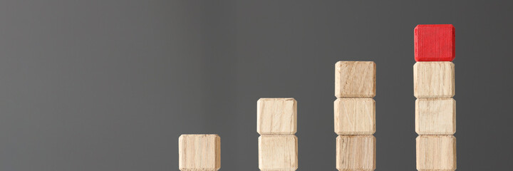 Wooden toy blocks stacked in shape of graphic