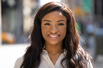 Young black woman in city smiling happy face portrait