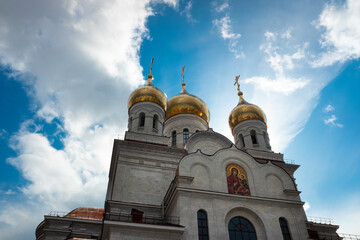 Orthodox Church on a background of blue sky with clouds.