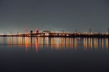 Beautiful shot of colorful bridge lights reflection on the water © Brodie Perfetto/Wirestock