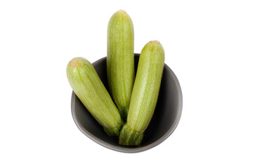 Baby courgette (zucchini) in a bowl isolated white background