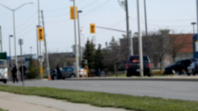 Police Accident Crime Scene Wide Angle Shot With Cleanup Crew Dump Trucks And Children Bicylists Onlooking Slight Camera Shake