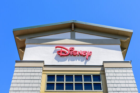 Disney sign on chain store facade under blue sky - Los Angeles, California, USA - 2021