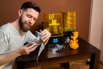 Man assembling finished figurine from 3d printer 