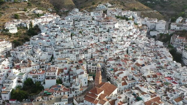 Aerial view of central areas of Competa overlooking parish Church of Assumption on sunny fall day, Andalusia, Spain. High quality 4k footage