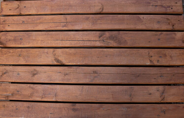Obraz premium A brown wooden boardwalk. Beautiful brown rustic background