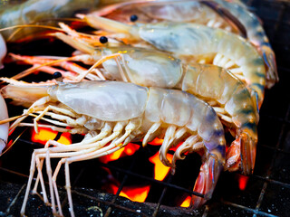 Grilled prawn on flaming grill.
