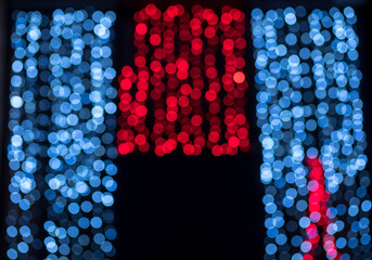 Blurred lights abstract bokeh of garland red and blue lighting.