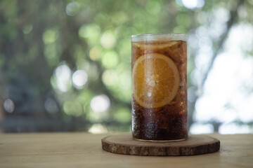 Glass of soft drink with orange slice. Summer drink