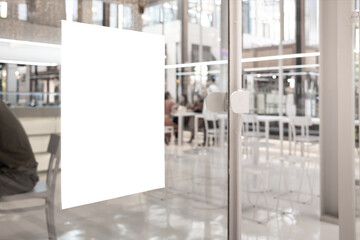 White paper mockup or white promotion poster displayed on the front of the restaurant, coffee shop Promotion information for marketing announcements and details - obrazy, fototapety, plakaty