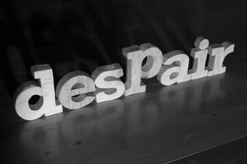 Despair, text words typography written with wooden letter on black background, life and business negativity