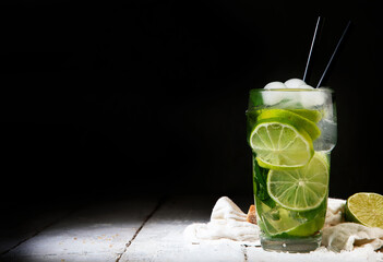 Fresh made Mojito cocktail on dark background. Summer drinks concept.