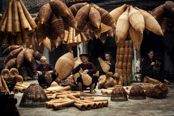 Craftsman making bamboo fish trap at old village, Hung Yen, Vietnam