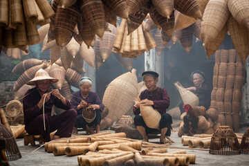 Craftsman making bamboo fish trap at old village, Hung Yen, Vietnam