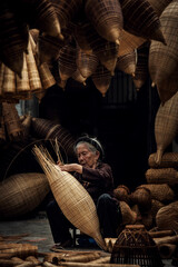 Craftsman making bamboo fish trap at old village, Hung Yen, Vietnam