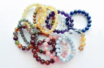 Collections of crystal gemstone bracelets on the table. 