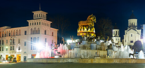 View of illuminated central square of Kutaisi with huge cascade structure of Colchis Fountain on spring night, Georgia