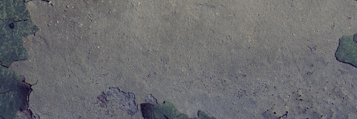 Peeling paint on the wall. Panorama of a concrete wall with old cracked flaking paint. Weathered rough painted surface with patterns of cracks and peeling. Wide panoramic grungy texture for background