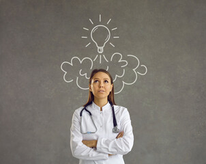 Nurse in lab coat and stethoscope looking up at line doodle light bulb shaped rocket flying above...