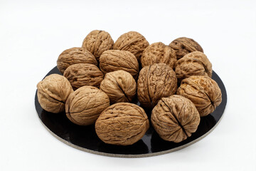 Many organic walnuts isolated on white background. Closed healthy walnuts