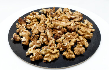 Walnut pile out its shell isolated on white background. Walnut kernels close up