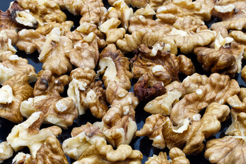 Walnut pile out its shell. Food background. Walnut kernels close up